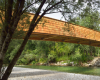 房产信息：DANSArchitects的拱形木制人行天桥将斯洛文尼亚乡村与山脉相连
